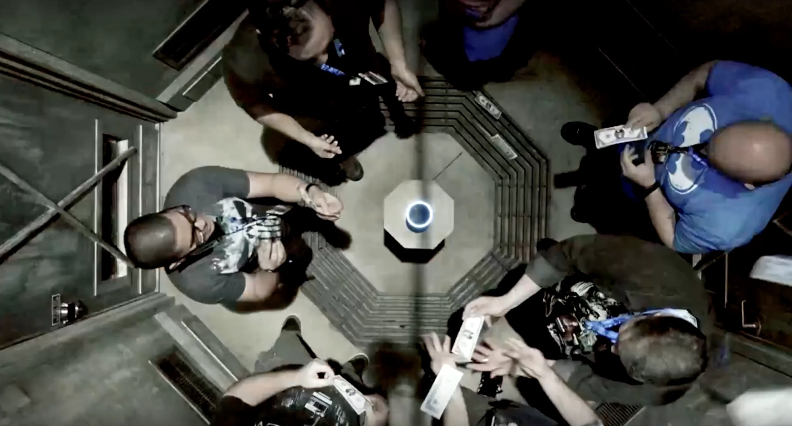 Overhead view of Echo Escape players for Amazon standing around an Echo speaker on a pedestal, some holding banknotes