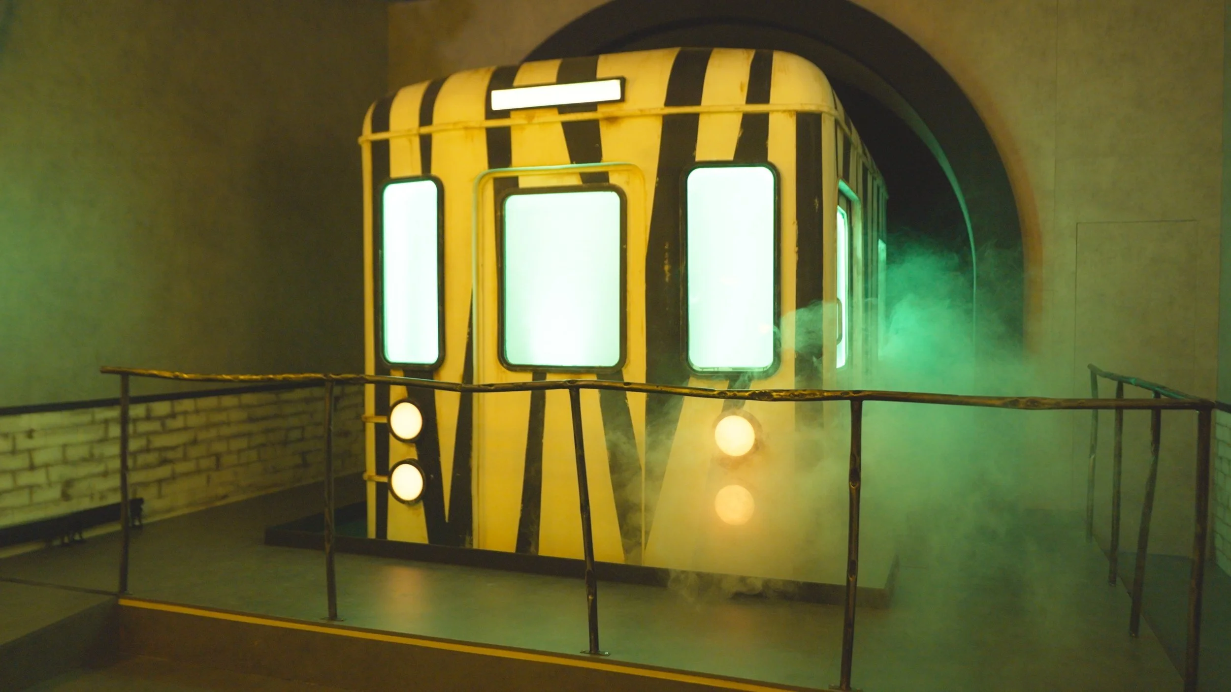 Black-and-white striped train carriage in green fog, set from Fanta's Escape the Afterlife Train Halloween campaign