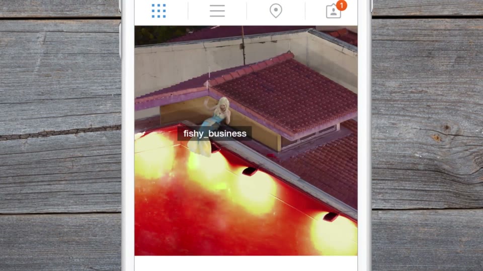 Canon Instazoom on a phone: a zoomed-in Instagram post of a red-tiled rooftop where a figure with a mermaid tail sits, tagged fishy_business
