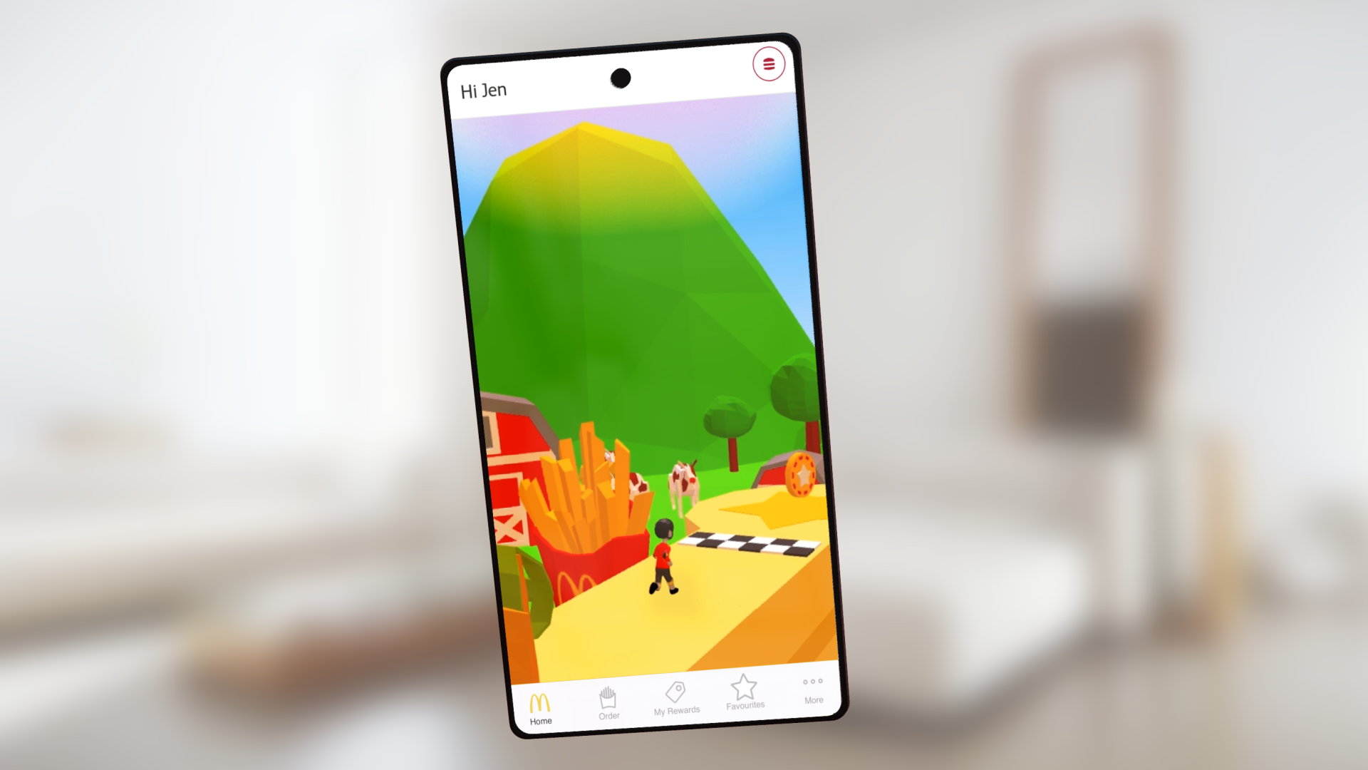 Macca's Run for McDonald's on a phone: under the app's Hi Jen greeting, a small runner in a red shirt passes a giant box of fries with golden arches towards a chequered line, above the Home, Order, My Rewards, Favourites and More tabs