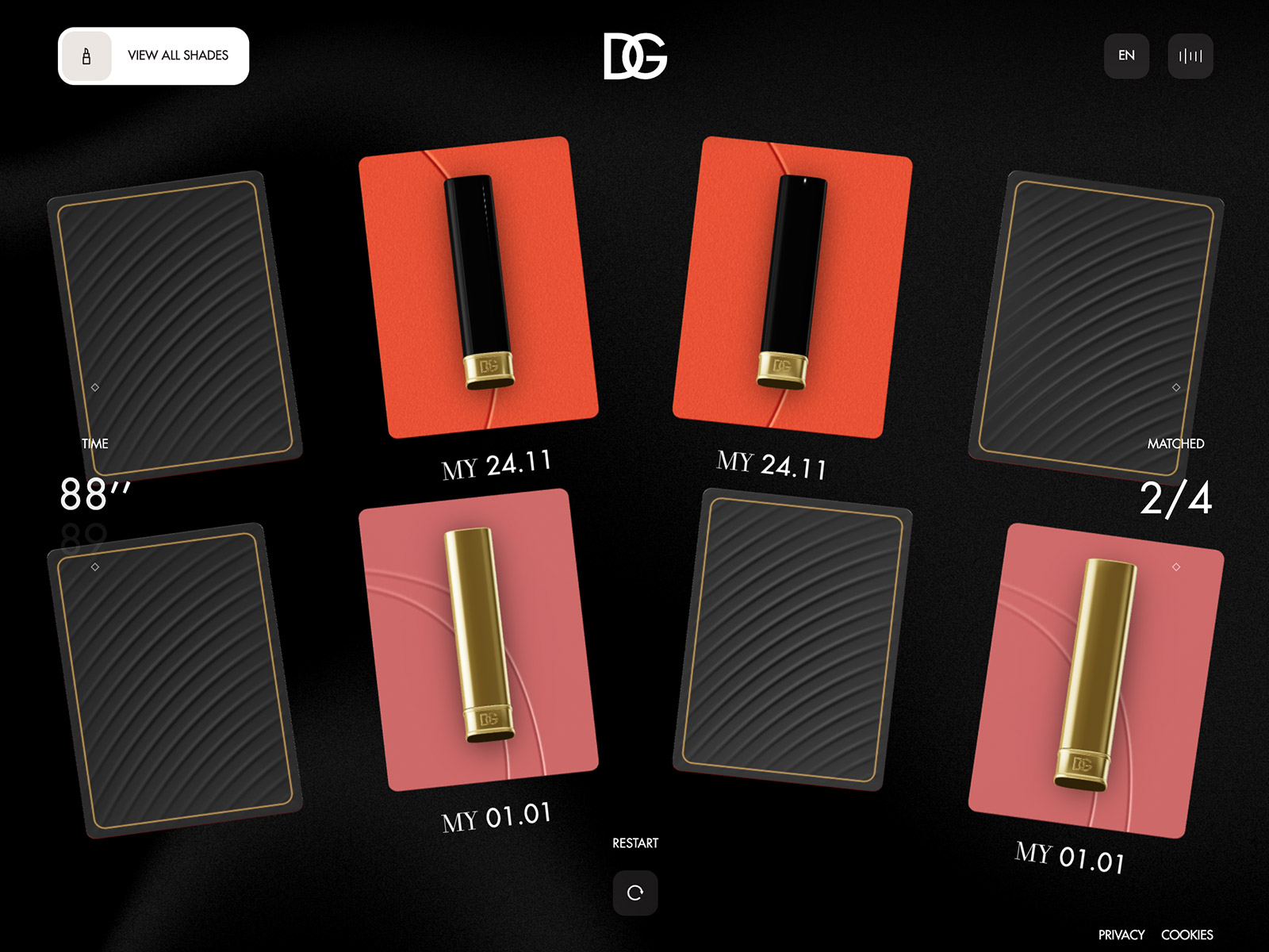 My Lip Stylo for DG Beauty: eight cards on black, four face down with gold-edged backs and two matched pairs of lipstick tubes labelled MY 24.11 and MY 01.01, with an 88-second timer and a 2/4 matched counter