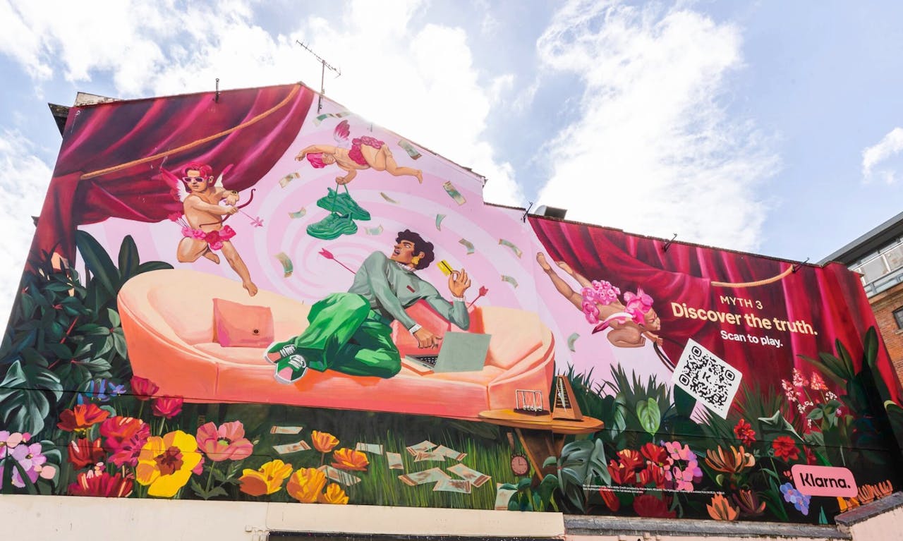 Klarna MythBuster Challenge mural on a building wall with a QR code and the line Discover the truth, Scan to play