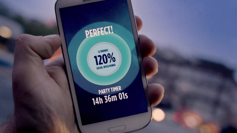 A phone held up outdoors shows a Perfect message and a party timer in Vodafone's The Party Starter app.